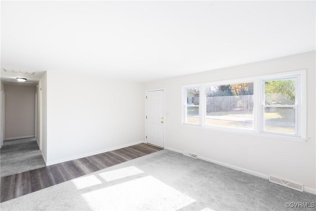 spare room featuring dark hardwood / wood-style flooring