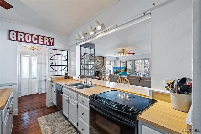 kitchen with black appliances, sink, ceiling fan, dark hardwood / wood-style floors, and butcher block counters