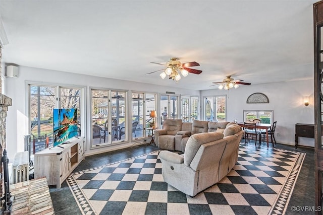 living room with a wall mounted air conditioner and ceiling fan