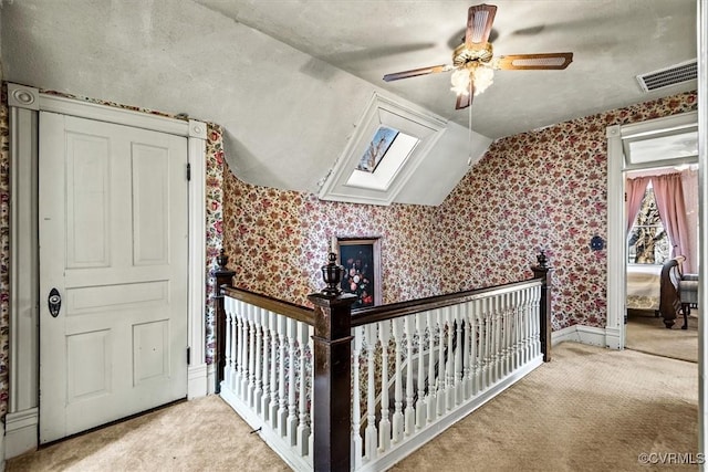 bonus room with ceiling fan, light colored carpet, and lofted ceiling with skylight