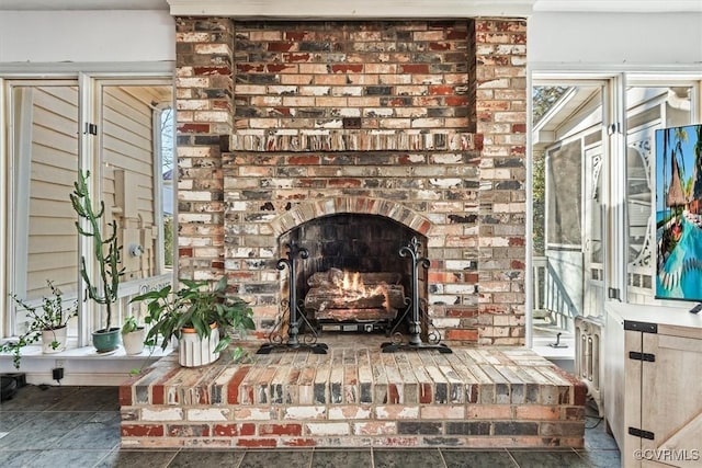 room details featuring a brick fireplace