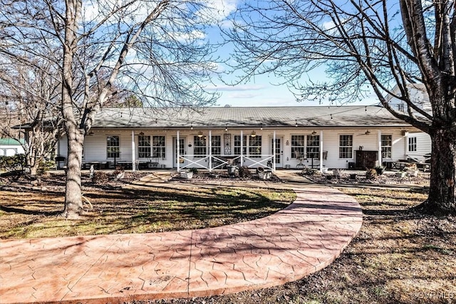 back of property featuring a lawn