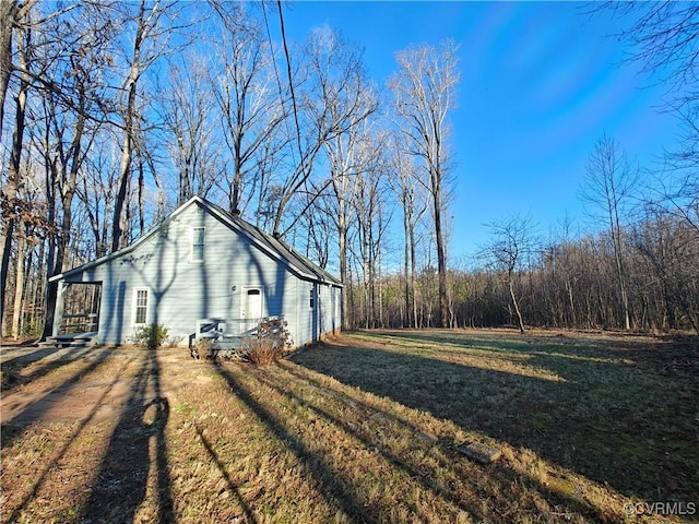 view of side of home with a lawn