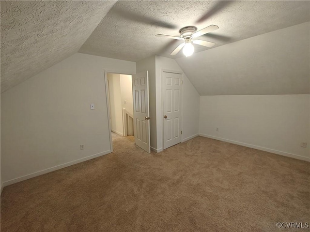 bonus room with ceiling fan, lofted ceiling, and a textured ceiling