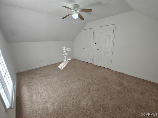 bonus room featuring ceiling fan, carpet flooring, and vaulted ceiling