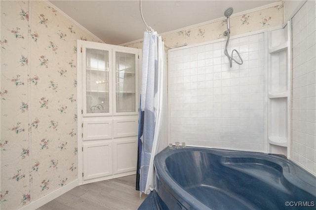 bathroom with shower / bathtub combination with curtain, ornamental molding, and hardwood / wood-style flooring