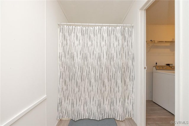 bathroom featuring hardwood / wood-style floors and washer / clothes dryer