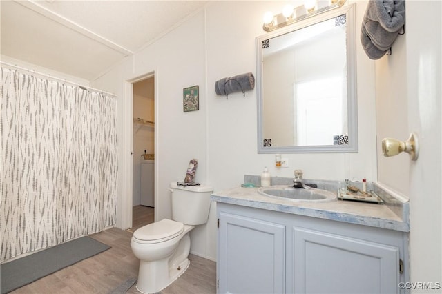 bathroom with hardwood / wood-style floors, vanity, and toilet