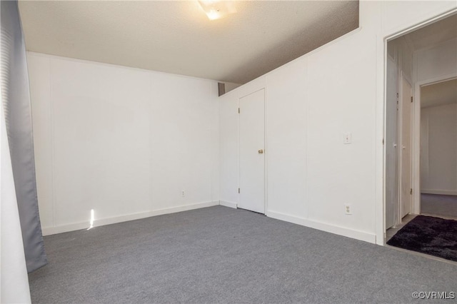 unfurnished bedroom with dark carpet