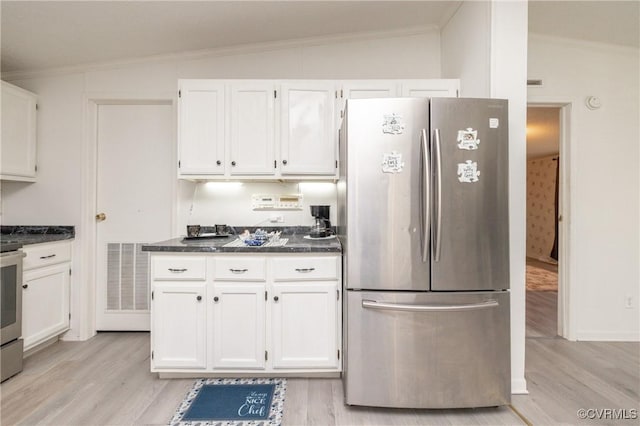 kitchen with white cabinetry, stainless steel appliances, and lofted ceiling