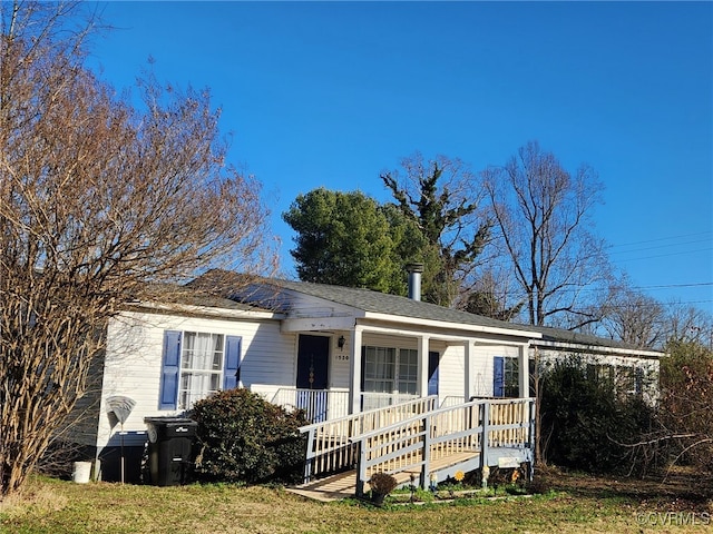 ranch-style house with a porch and a front lawn