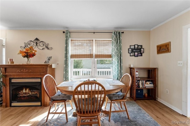 dining room featuring light wood-type flooring and ornamental molding