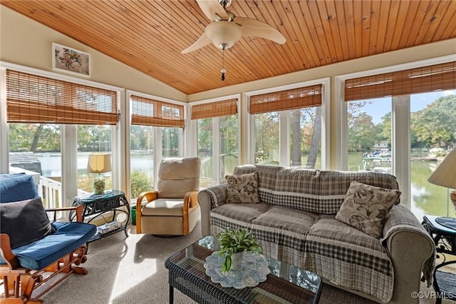 sunroom / solarium with ceiling fan, a water view, wooden ceiling, and vaulted ceiling