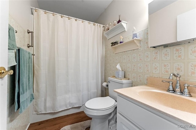 full bathroom with shower / bath combo, vanity, hardwood / wood-style flooring, and toilet