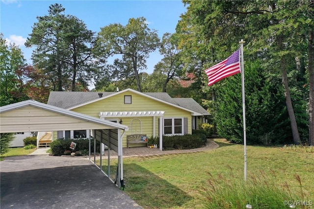 view of front of property with a front yard and a carport