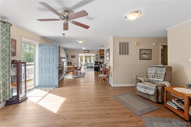 interior space with light hardwood / wood-style flooring, ceiling fan, and ornamental molding