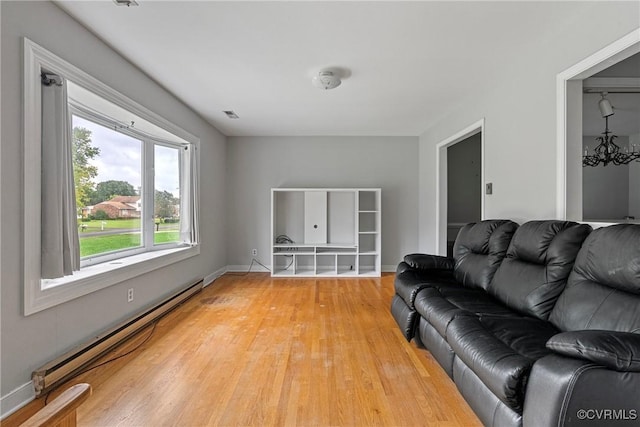 living room with light hardwood / wood-style floors and baseboard heating