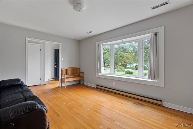 living room with hardwood / wood-style floors and a baseboard radiator