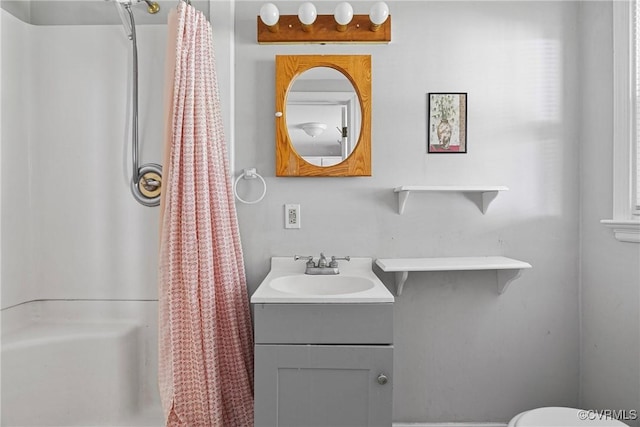 bathroom with a shower with shower curtain, vanity, and a wealth of natural light