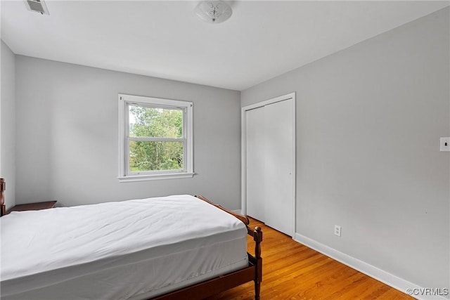 bedroom featuring a closet and hardwood / wood-style flooring