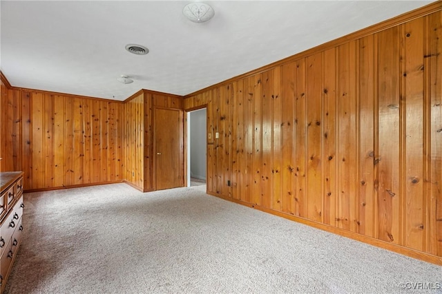 unfurnished room with carpet and ornamental molding