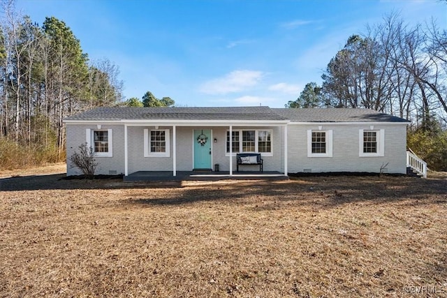 single story home featuring crawl space, brick siding, and a front lawn