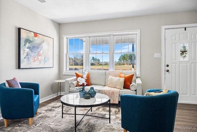 living room featuring a wealth of natural light, dark wood finished floors, and baseboards