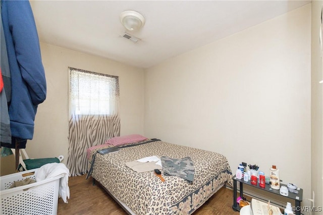 bedroom with dark hardwood / wood-style flooring