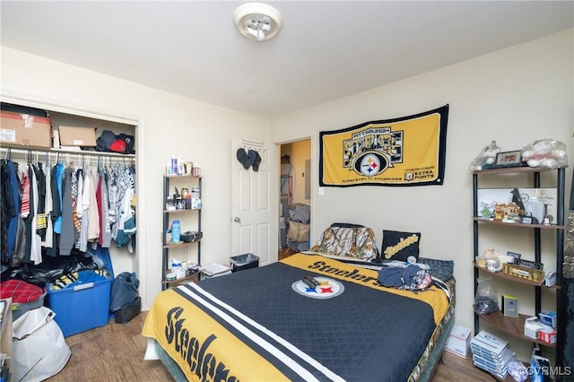 bedroom with wood-type flooring and a closet