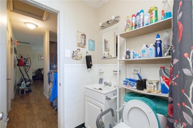 bathroom with hardwood / wood-style floors, vanity, and toilet