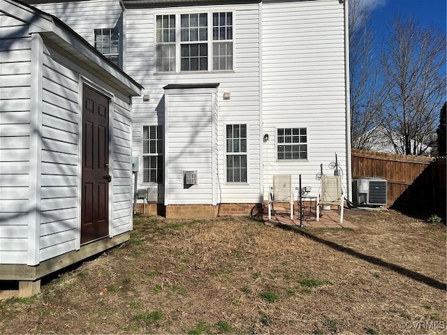 back of property featuring central air condition unit