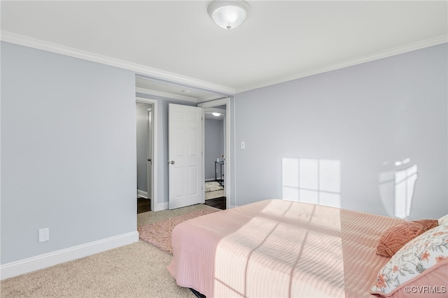 bedroom featuring crown molding and carpet