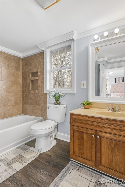 full bathroom with ornamental molding, vanity, hardwood / wood-style flooring, toilet, and tiled shower / bath