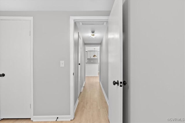 corridor with light hardwood / wood-style flooring