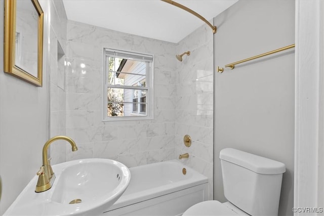 full bathroom featuring sink, tiled shower / bath combo, and toilet