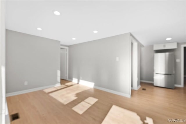 unfurnished room with light wood-type flooring