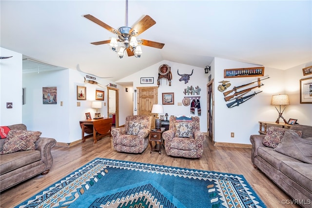 living room with hardwood / wood-style floors, vaulted ceiling, and ceiling fan