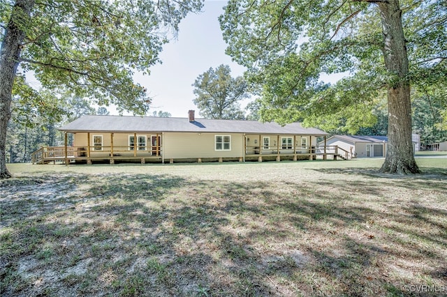 rear view of property featuring a yard