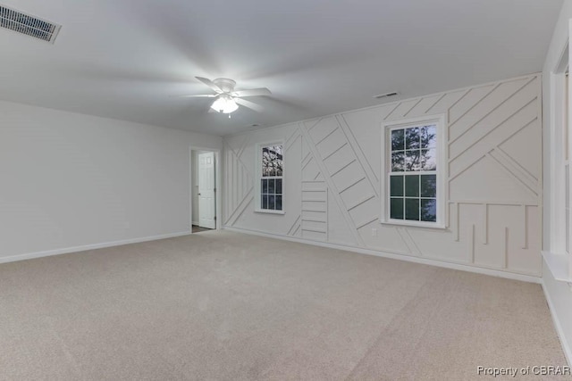 carpeted empty room featuring ceiling fan