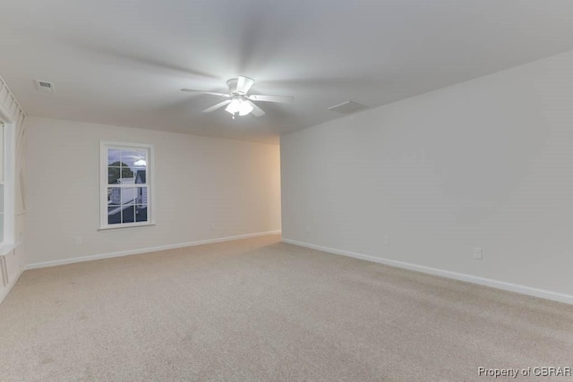 carpeted empty room featuring ceiling fan