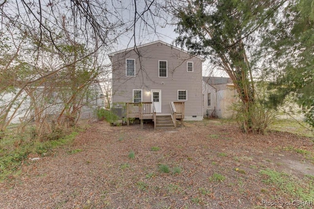 back of house featuring a wooden deck