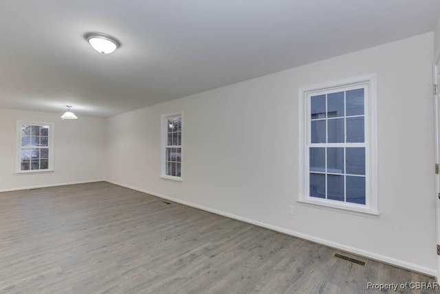 unfurnished room featuring hardwood / wood-style floors