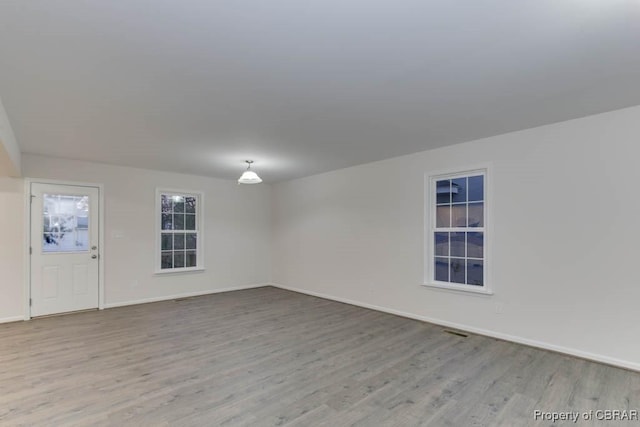 spare room with light hardwood / wood-style flooring