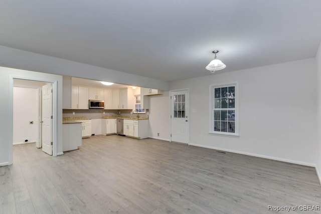 unfurnished living room with light wood-type flooring