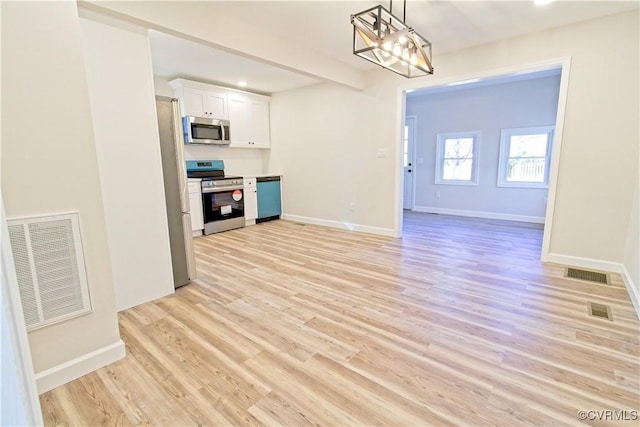 unfurnished living room featuring light hardwood / wood-style flooring and a chandelier