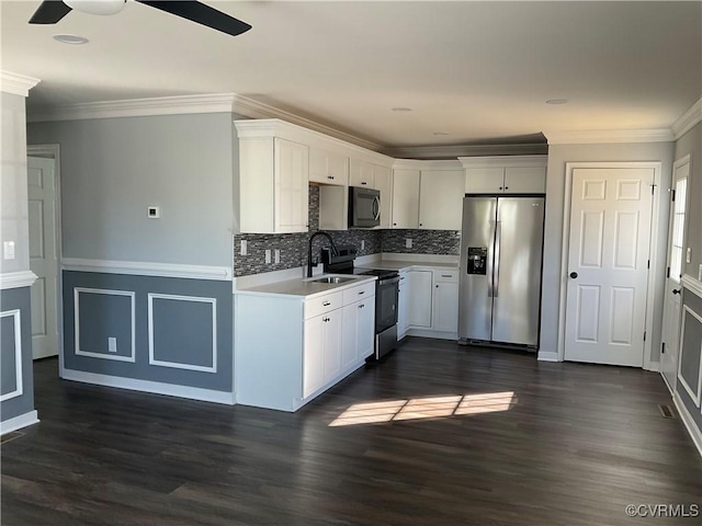 kitchen featuring white cabinetry, sink, appliances with stainless steel finishes, and dark wood-type flooring