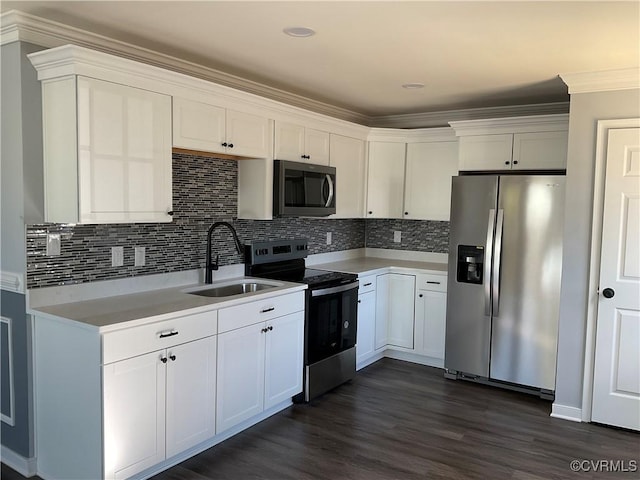 kitchen with white cabinets, crown molding, sink, dark hardwood / wood-style floors, and appliances with stainless steel finishes