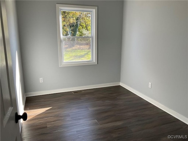 spare room with dark hardwood / wood-style flooring