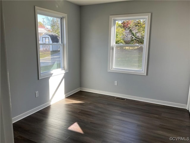 empty room with dark wood-type flooring