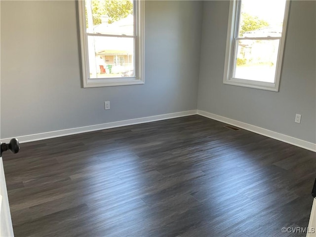 unfurnished room featuring dark hardwood / wood-style flooring